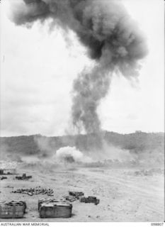 VULCAN, RABAUL AREA, NEW BRITAIN. 1945-11-14. THE LARGE COLUMNS OF SMOKE CAUSED BY THE DESTRUCTION OF APPROXIMATELY 20 TONS OF JAPANESE AMMUNITION. IT WAS DESTROYED BY MEMBERS OF HEADQUARTERS 11 ..