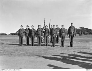 MOUNT MARTHA, VIC. 1943-05-18. ESCORTED BY THE COLOUR GUARD, EIGHT MEMBERS OF THE U.S. MARINE CORPS STAND BEFORE THE REVIEWING STAND. THEY ARE TO BE DECORATED FOR GALLANTRY ON GUADALCANAL BY MAJOR ..