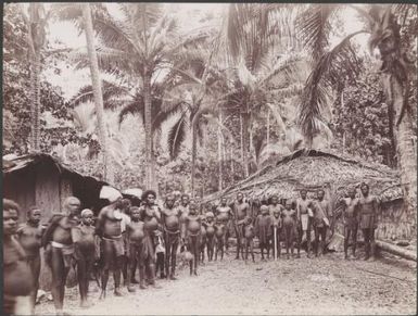 Villagers amongst buildings at Nimbi, Te Motu, Santa Cruz Islands, 1906 / J.W. Beattie