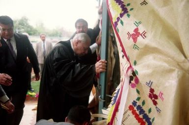 King Taufa'ahau Tupou IV, King of Tonga, entering church Vaine Mo'onia through a portal of fine mats