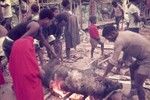 Singeing a pig prior to butchering and cooking for ritual exchange