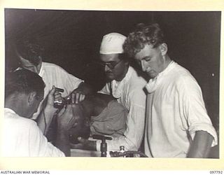 RABAUL, NEW BRITAIN, 1945-10-08. A TUBE BEING PUSHED DOWN INTO THE TRACHEA OF A PATIENT BEFORE THE COMMENCEMENT OF AN OPERATION AT THE DENTAL SECTION, 105 CASUALTY CLEARING STATION. THE OPERATION ..