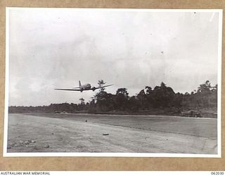 DREGER HARBOUR, NEW GUINEA. 1943-12-07. A DOUGLAS TRANSPORT IS THE FIRST LARGE AIRCRAFT TO LAND ON THE NEW STRIP BUILT BY THE 870TH UNITED STATES AVIATION BATTALION