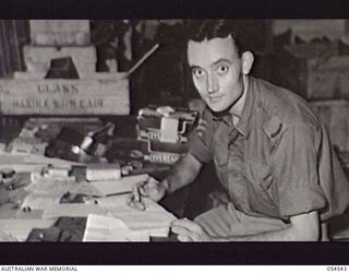 MILNE BAY, NEW GUINEA, 1943-07-12. PORTRAIT OF QX50998 STAFF SERGEANT L. C. THOMPSON, COMPANY QUARTERMASTER SERGEANT, HEADQUARTERS, 5TH AUSTRALIAN DIVISION AT WORK IN HIS OFFICE