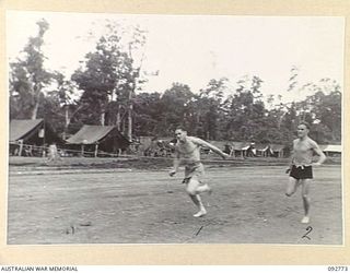 SORAKEN, BOUGAINVILLE. 1945-06-03. PRIVATE LOVELL, 13 FIELD BAKING PLATOON ATTACHED 223 SUPPLY DEPOT (1), COMING FIRST IN THE 220 YARDS RACE AT HEADQUARTERS 11 INFANTRY BRIGADE. HE IS FOLLOWED BY ..