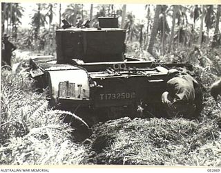 MADANG, NEW GUINEA. 1944-10-12. THE REAR VIEW OF A BOGGED CHURCHILL V TANK AT HQ 4 ARMOURED BRIGADE