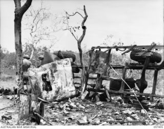 PORT MORESBY AREA, NEW GUINEA, 1943-09-14. ONE OF FIVE TRUCKS CARRYING MEMBERS OF THE 2/33RD BATTALION AND THE 158TH GENERAL TRANSPORT COMPANY, WHICH WAS DESTROYED WHEN A LIBERATOR BOMBER CRASHED ..