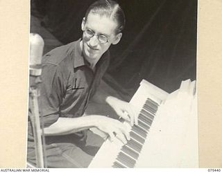 MILILAT, NEW GUINEA. 1944-08-23. TX14842 STAFF SERGEANT D.J. MILEY, PIANIST AND MUSICAL DIRECTOR OF THE "TASMANIACS", THE TASMANIAN LINES OF COMMUNICATION CONCERT PARTY PRACTISING DURING A ..