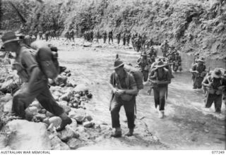 Doyabie Area, Bougainville. 1944-11-23. Troops of the 9th Infantry Battalion, 7th Australian Infantry Brigade, crossing the Laruma River near the end of the Numa Numa Trail. They were moving ..
