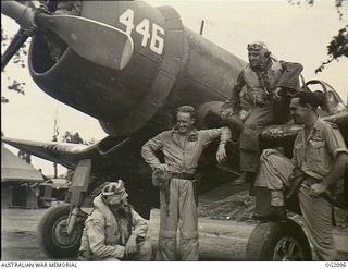 PIVA AIRFIELD, TOROKINA, BOUGAINVILLE ISLAND, SOLOMON ISLANDS. C. 1945-01-16. AIRCREW PERSONNEL OF THE RAAF AND ROYAL NEW ZEALAND AIR FORCE COMPARING NOTES AROUND THE NEW ZEALAND CORSAIR AIRCRAFT, ..