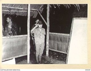 TOKO, BOUGAINVILLE. 1945-08-18. MAJOR OTSU, THE JAPANESE SURRENDER ENVOY ENTERING A HUT AT HEADQUARTERS 3 DIVISION TO BE INTERROGATED BY BRIGADIER A.R. GARRETT, BGS, HEADQUARTERS 2 CORPS