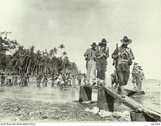 BABIANG, NEW GUINEA. 1944-11-07. A PATROL FROM C TROOP, 2/10 COMMANDO SQUADRON MOVING OUT AFTER DAWN, LEADS THE SQN OVER THE DANDRIWAD RIVER AT BABIANG, WATCHED BY NATIVES IN THE BACKGROUND. ..