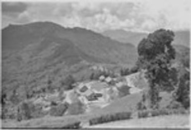 Tabibuga patrol post: distant view of government buildings, trail, and Bismarck Range