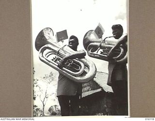 NEW GUINEA. 1943-11-11. THE NEWLY FORMED BAND OF THE ROYAL PAPUAN CONSTABULARY IS SHOWN AT PRACTICE. SOME OF THE PLAYERS HAVE ONLY JUST COMMENCED MUSIC. THE FIRST NUMBER THEY HAVE MASTERED IS "GOD ..