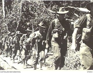 FARIA RIVER, NEW GUINEA, 1944-02-15. MEMBERS OF "A" COMPANY OF THE 57/60TH INFANTRY BATTALION CROSSING A BRIDGE IN THEIR MARCH UP THE FARIA RIVER TO RELIEVE THE 2/9TH INFANTRY BATTALION AT THE ..