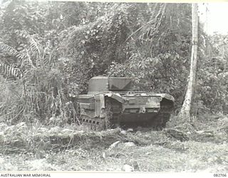 MADANG, NEW GUINEA. 1944-10-12. A CHURCHILL VII TANK PASSING THROUGH DENSE UNDERGROWTH DURING TESTS CONDUCTED AT HQ 4 ARMOURED BRIGADE