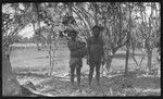 Man, and woman with child in carrying sling