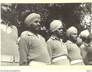 BRISBANE, QUEENSLAND, AUSTRALIA. 1944-08-08. INDIAN SIKH SOLDIERS, EX-PRISONERS OF WAR, WHO ARE RECENTLY FREED BY THE ALLIED CAPTURE OF MANUS ISLAND, WATCHING THE 7TH DIVISION MARCH THROUGH THE ..