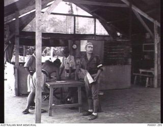 THE SOLOMON ISLANDS, 1945-10-18. JAPANESE SERVICE PERSONNEL CONDUCTING ADMINISTRATIVE PROCEDURES AT THEIR INTERNMENT CAMP AT TOROKINA, BOUGAINVILLE ISLAND. (RNZAF OFFICIAL PHOTOGRAPH.)