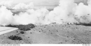 NADZAB, NEW GUINEA. 1943-09-05. UNITED STATES C47 AIRCRAFT FLYING IN OVER THE NADZAB DROP ZONE BEHIND A SMOKE SCREEN LAID DOWN BY A20 (BOSTON) AIRCRAFT DURING THE AIRBORNE ASSAULT DELIVERING MEN OF ..