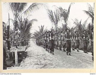 JACQUINOT BAY, NEW BRITAIN, 1945-07-01. HIS ROYAL HIGHNESS, THE DUKE OF GLOUCESTER, GOVERNOR-GENERAL OF AUSTRALIA (1), TAKING THE SALUTE FROM TROOPS OF HEADQUARTERS 5 DIVISION IN THE MARCH PAST AT ..