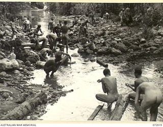 KILIGIA, PAPUA, NEW GUINEA. 1944-04-03. ALLIED SERVICEMEN FROM UNITS IN THE VICINITY AT HEADQUARTERS 5TH DIVISION BATHING, WASHING, AND SHAVING IN THE SHALLOW WATER NEAR THE MOUTH OF THE TUNOM ..