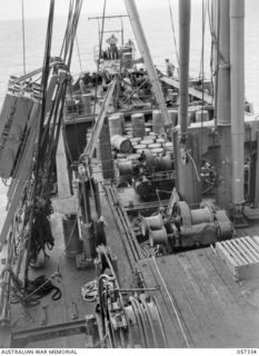 BOERA POINT, NEW GUINEA. 1943-10-01. LOOKING TOWARDS THE BOWS OF THE SS MERNOO MARINE CABLE LAYING SHIP SHOWING CABLE RUNS, SHEAVES AND DYNAMOMETER. THIS VESSEL IS LAYING A CABLE FROM CAPE YORK TO ..