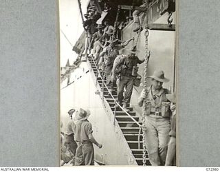 SAIDOR, NEW GUINEA. 1944-04-24. TROOPS OF THE 5TH DIVISION MOVE DOWN THE GANGPLANK OF THE AMERICAN LIBERTY SHIP DAVID E. HUGHES AT THE COMPLETION OF A 21 HOUR JOURNEY FROM LANGEMAK BAY