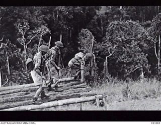 DONADABU, SOGERI VALLEY, NEW GUINEA. 1943-06-28. 25TH INFANTRY BATTALION ASSAULT COURSE. FIRST OBSTACLE - BALANCING ON NARROW PLANKS. LEFT TO RIGHT: Q22310 PRIVATE (PTE) H. L. KINNEAR; N272145 PTE ..