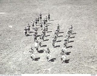 WONDECLA, QLD. 1944-04-23. BAND OF THE 2/1ST INFANTRY BATTALION PRACTICING ROUTINE MARCHES ON THE HERBERTON RACECOURSE