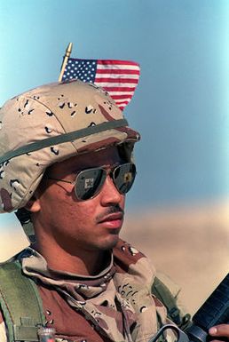 Lance CPL. Sidney Aviz, a Marine deployed aboard the amphibious assault ship USS GUAM (LPH-9), wears an American flag in his helmet during exercise Imminent Thunder, a readiness exercise conducted by forces operating in the Persian Gulf region in support of Operation Desert Shield