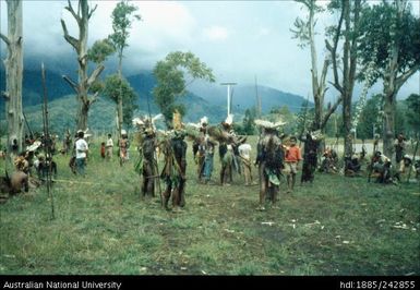 Males standing together holding tools