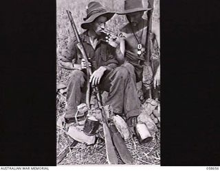 RAMU VALLEY, NEW GUINEA. 1943-10-06. NX47345 SAPPER K. G. NILSEN (LEFT) AND NX87622 SAPPER W. J. MARKS BOTH OF THE 2/6TH AUSTRALIAN FIELD COMPANY, ROYAL AUSTRALIAN ENGINEERS, PAUSE FOR A SMOKE ..