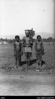 Police officer with other individuals in  Maia village in Schrader Range