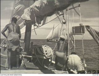 PORT MORESBY, PAPUA. C. 1944. PAPUAN NATIVES EMPLOYED AS CREW MEMBERS ON A SAILING VESSEL USED BY THE RAAF RESCUE SERVICE. IN THE BACKGROUND IS A SECOND SAILING VESSEL, PROBABLY THE WAITARA, USED ..