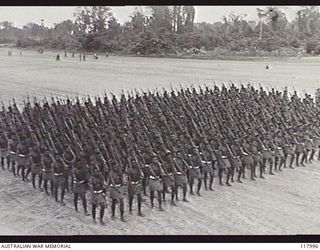 TOROKINA, BOUGAINVILLE. 1945-10-29. MEMBERS OF THE PAPUAN INFANTRY BATTALION MOVING TOWARDS THE SALUTING BASE WHERE THE COMMANDER IN CHIEF, AUSTRALIAN MILITARY FORCES, IS TAKING THE SALUTE DURING A ..