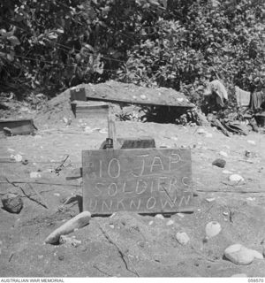 FINSCHHAFEN AREA, NEW GUINEA, 1943-10-23. TEMPORARY BOARD ERECTED OVER THE MASS GRAVE OF TEN JAPANESE SOLDIERS UNKNOWN, WHO WERE KILLED DURING THE LANDINGS ON SCARLET BEACH