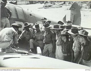 TOROKINA, BOUGAINVILLE ISLAND. 1944-12-23. 403921 FLYING OFFICER R.H. GLASSOP, NO.5 TACTICAL RECONNAISSANCE SQUADRON, RAAF SHOWING TROOPS OF THE 1ST INDIAN HEAVY ANTI-AIRCRAFT REGIMENT THE MACHINE ..