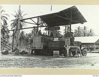 MILNE BAY, PAPUA, NEW GUINEA. 1944-04-03. AUSTRALIAN AND AMERICAN MOTOR TANKERS BEING FILLED WITH 80 OCTANE MOTOR SPIRIT AT THE 2ND BULK PETROLEUM STORAGE COMPANY. THE FUEL IS FOR DISTRIBUTION TO ..