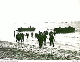 THE SOLOMON ISLANDS, 1945-01-13. TROOPS DISEMBARKING FROM LANDING CRAFT AT A BOUGAINVILLE ISLAND BEACH. (RNZAF OFFICIAL PHOTOGRAPH.)