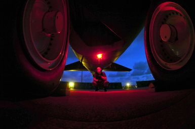 US Air Force (USAF) SENIOR AIRMAN (SRA) William Fay, a B-52 Stratofortress aircraft Crew CHIEF assigned to the 5th Bomb Wing (BW), inspects the warning light inside the aft landing gear wheel well of his aircraft, during night operations on the flight line at Andersen Air Force Base (AFB), Guam. (SUBSTANDARD)