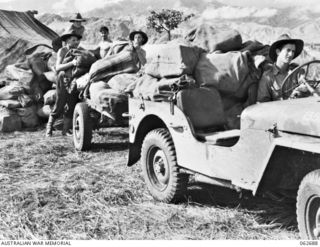 DUMPU, NEW GUINEA. 1943-12-22. PERSONNEL OF FORWARD POST OFFICE 28, 7TH AUSTRALIAN DIVISION POSTAL UNIT LOADING BAGS OF CHRISTMAS PARCELS AND LETTERS ON TO JEEPS FOR DELIVERY TO FORWARD AREAS. ..