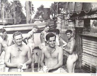 MADANG, NEW GUINEA. 1944-08-15. TROOPS OF THE 165TH GENERAL TRANSPORT COMPANY ENJOYING A REFRESHING WASH UNDER THE UNIT SHOWERS AT THE END OF THEIR DAY'S WORK. IDENTIFIED PERSONNEL ARE:- NX125248 ..