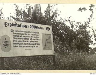 FINSCHHAFEN AREA, NEW GUINEA. 1944-03-13. ONE OF MANY BATTLE SIGNS IN THE FINSCHHAFEN AREA, THIS SIGN RECORDS EXPLOITATION TO THE 2,000' FEATURE BY "B", "C" AND "D" COMPANIES, 2/24TH INFANTRY ..