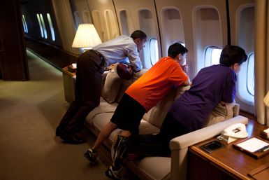President Barack Obama with Nicky and Zachary DeParle aboard Air Force One