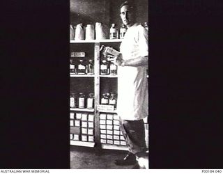 BUNA. 1944-05. CAPTAIN LOWE, AUSTRALIAN ARMY MEDICAL CORPS, IN THE BLOOD BANK AT BUNA