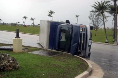 A truck lay tipped over in front of the 36th Air Base Wing (ABW) building as a result of super-typhoon Pongsona Sunday December 8th at Andersen Air Force Base (AFB), Guam