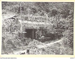 KANGU HILL, BOUGAINVILLE. 1945-10-05. JAPANESE POWER STATION CONSTRUCTED IN SIDE OF KANGU HILL. IT WAS USED TO RELAY POWER TO WIRELESS STATIONS IN THE BUIN AREA. THE AREA IS NOW OCCUPIED BY TROOPS ..