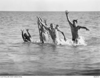 ELA BEACH, NEW GUINEA. 1944-01-05. AUSTRALIAN TROOPS ENJOYING A BALL GAME IN THE SEA OFF ELA BEACH