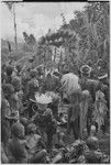 Bride price ritual: people surround payment banner of feather and shell valuables